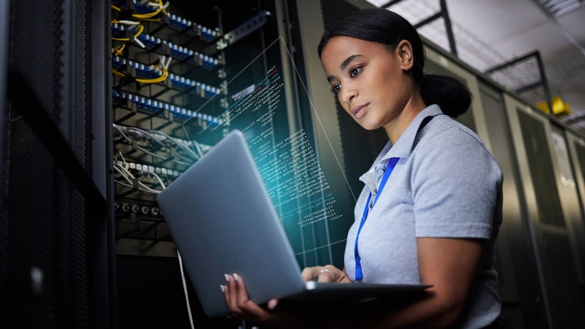 Woman with a laptop in a data centre