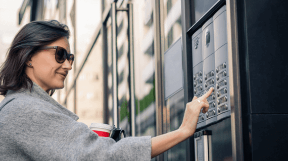 Smiling woman using intercom at building entrance (202606120)_Small.png (120.4 KB)